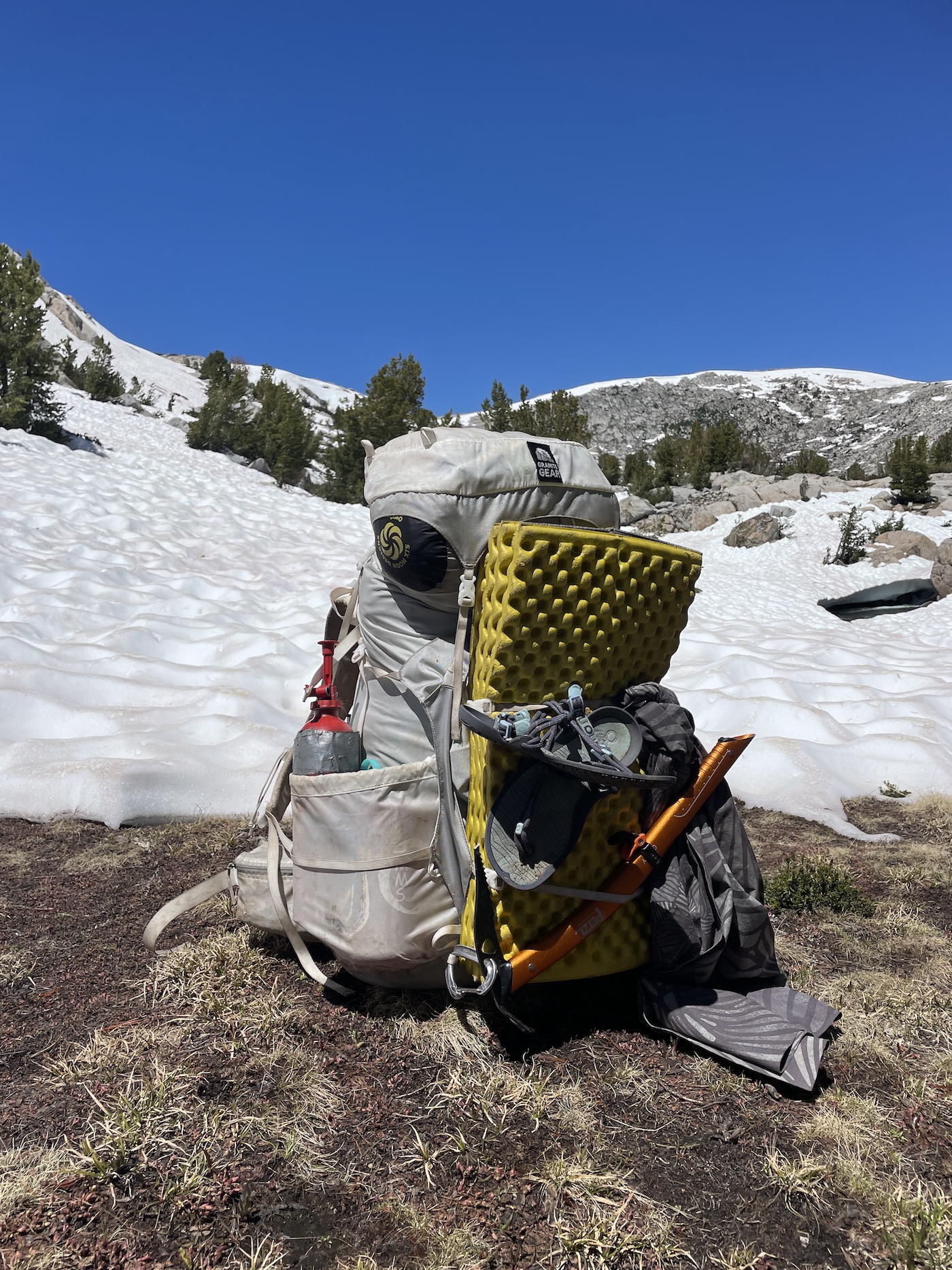 Backpacking gear attached to hiking pack